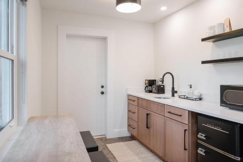 a kitchen with a sink and a microwave at Haley's Court Boutique Motel in Saint Augustine