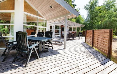 a wooden deck with a table and chairs on it at Holiday Home Hjortestien Højby X in Lumsås