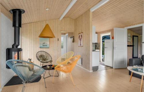 a living room with chairs and a table and a stove at Lovely Home In Slagelse With Wifi in Slagelse