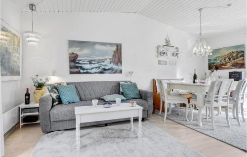 a living room with a couch and a table at 2 Bedroom Lovely Apartment In Nexø in Neksø