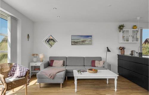a living room with a couch and a table at Lovely Home In Skagen With Wifi in Skagen