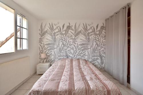 une chambre avec un lit avec un papier peint fleuri dans l'établissement La Halte Décinoise - Maison de avec jardin 103m2, à Vaulx-en-Velin