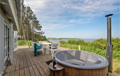 a bath tub on the deck of a house at Three-Bedroom Holiday Home In Knebel in Knebel