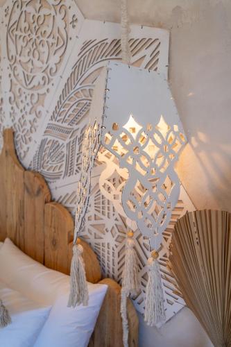 a chandelier hanging from the ceiling of a bedroom at Art Cabin At The Beach in Langstrand