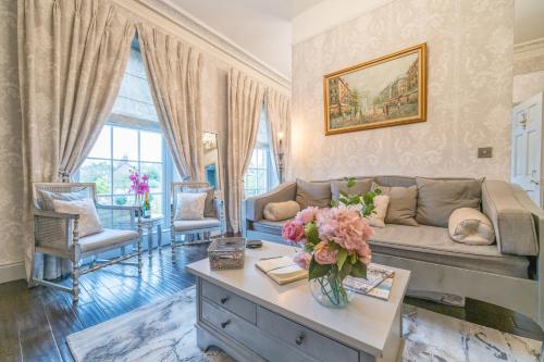 a living room with a couch and a table at Beautifully decorated, elegant apartment near town - Pass the Keys in Shrewsbury