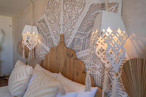 a bed with a wooden headboard with lights on it at Art Cabin At The Beach in Langstrand
