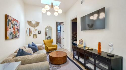a living room with a couch and a table at Bonsoir in New Orleans