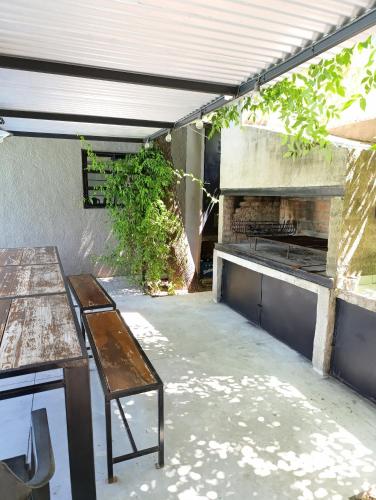 an outdoor patio with a table and a stove at La escondida in Ramallo