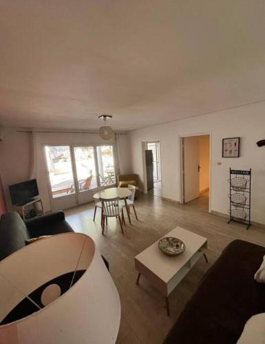 a living room with a couch and a table at Ti Coin Boucan - Proche Plage in Boucan Canot
