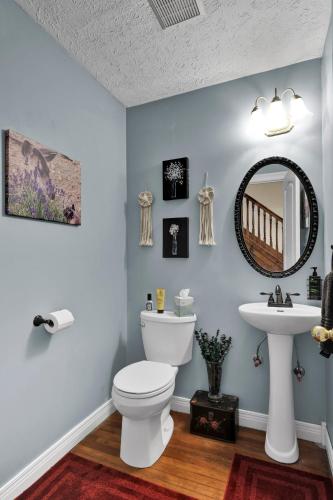 a bathroom with a toilet and a sink at Hill House Bed and Breakfast in Loretto