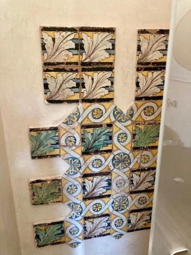 a wall with a mosaic design on it at Boutique Hotel Masseria Sottomasi in Savelletri di Fasano