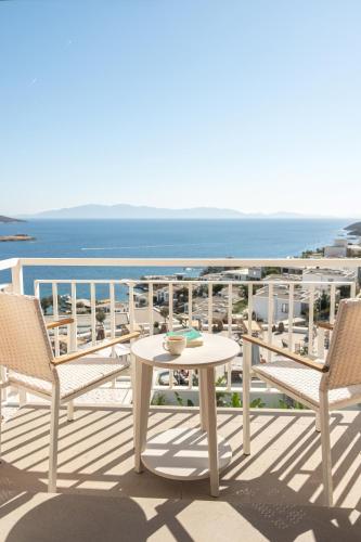 a table and chairs on a balcony with a view of the ocean at Doria Hotel Bodrum-City Center in Bitez