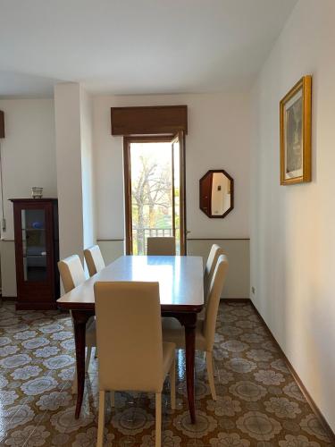 a dining room with a wooden table and chairs at Green House Caldiero in Caldiero
