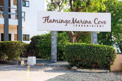 a sign in front of a building with bushes at Newly Remodeled Ground-Floor Unit in Flamingo in Front of Beach in Playa Flamingo