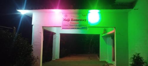 a building with green and pink lights on it at Maji Homestay Khajuraho in Khajurāho