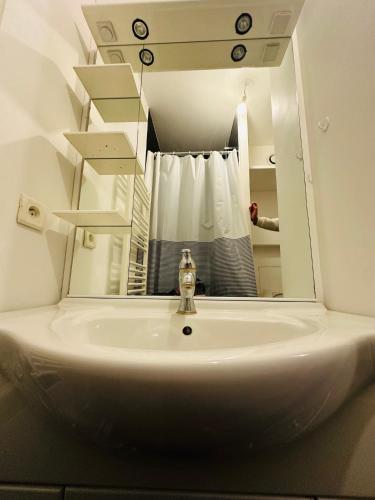 une salle de bain avec un lavabo et un miroir dans l'établissement Necker Paris, à Paris