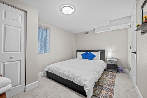 a bedroom with a bed with a blue pillow on it at Iola in Aurora