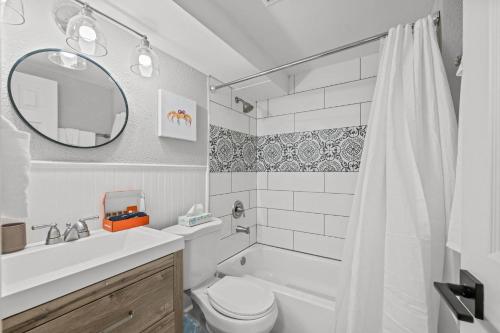 a bathroom with a sink toilet and a mirror at Iola in Aurora