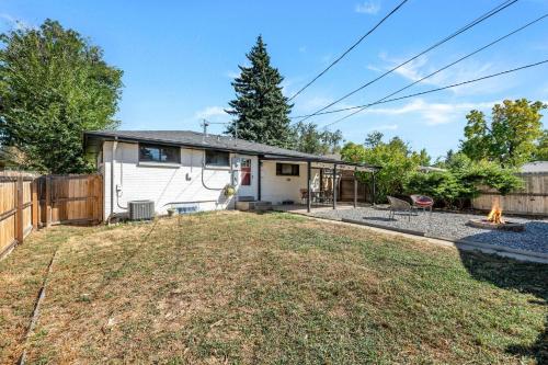 a house with a backyard with a fire pit at Iola in Aurora