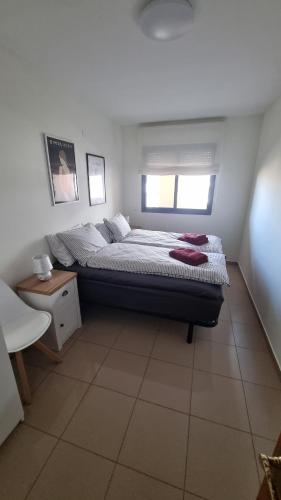 a bedroom with a bed and a window in it at Ap Skerup Calpe City cerca Playa in Calpe