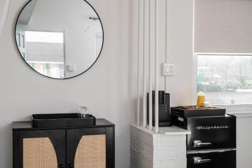 a bathroom with a mirror on the wall and a sink at Haley's Court Boutique Motel in Saint Augustine