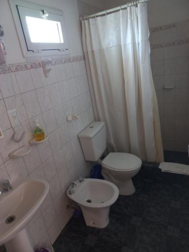 a bathroom with a toilet and a sink at Amien Patagonia in Puerto Madryn