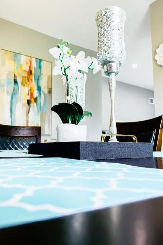 a table with a blue table cloth and a vase at 2 Homes, 1 Stay-7BR Niagara Falls Compound in Niagara Falls