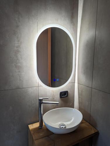 a bathroom with a sink and a mirror at Cubo House in Lamezia Terme
