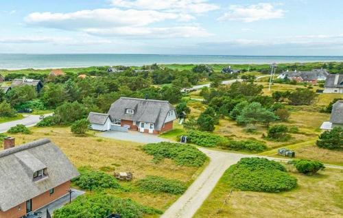 an aerial view of a house with the ocean in the background at Beautiful Home In Blåvand With Sauna in Blåvand