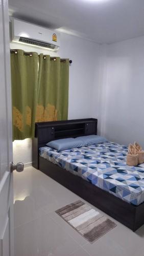 a bedroom with a bed in a room with a curtain at CG BNB HOTEL in Chiang Mai