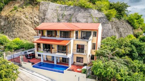 an aerial view of a house with a mountain at 2 Bedroom Ocean-View Condo with Pool in Playa Flamingo