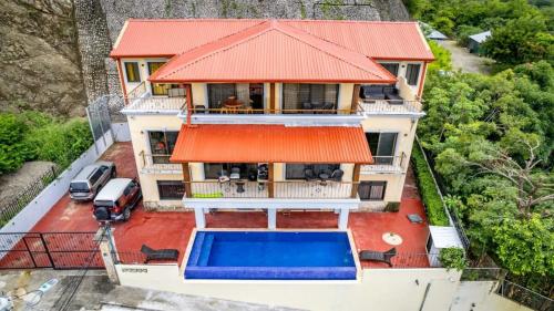 an aerial view of a house with a swimming pool at 2 Bedroom Ocean-View Condo with Pool in Playa Flamingo
