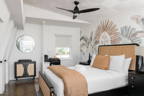 a bedroom with a bed and a ceiling fan at Haley's Court Boutique Motel in Saint Augustine