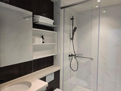 a bathroom with a shower and a sink at BaySuites Likas by Alawa Homes in Kota Kinabalu