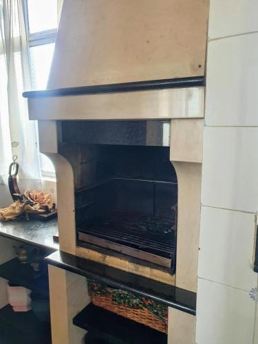 an oven with its door open in a kitchen at TR House Amadora in Amadora