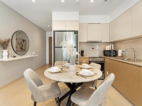 a kitchen and dining room with a table and chairs at SmartStay at Burj Royale - Full Burj Khalifa View - Brand New Luxury Apartments in Dubai
