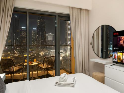 a hotel room with a view of a city at SmartStay at Burj Royale - Full Burj Khalifa View - Brand New Luxury Apartments in Dubai