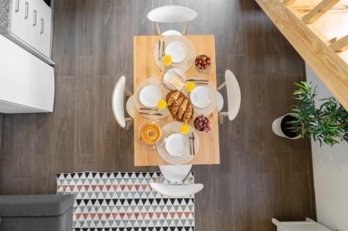 a table with a plate of food on it at Host Wise - Stylish Duplex House - Terrace & River View in Vila Nova de Gaia