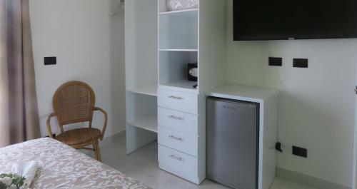 a bedroom with a bed and a tv on a wall at All Seasons Hotel in Bayahibe