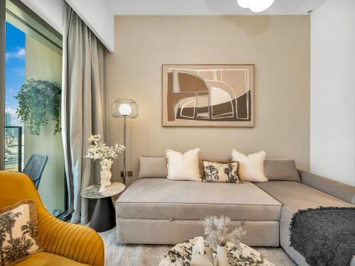 a living room with a bed and a couch at SmartStay at Burj Royale - Full Burj Khalifa View - Brand New Luxury Apartments in Dubai