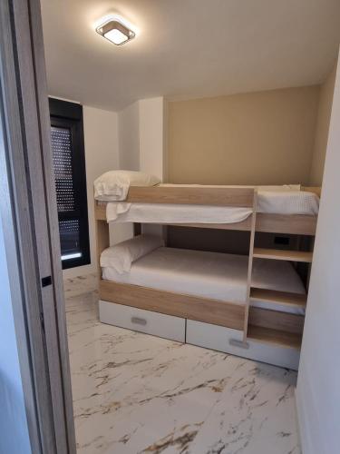 a small room with two bunk beds in it at Aguete III in Marín