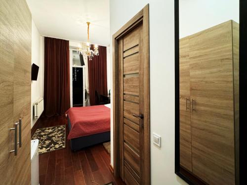 a small room with a door and a bedroom at SIGNEEV'S Villa in Kyiv