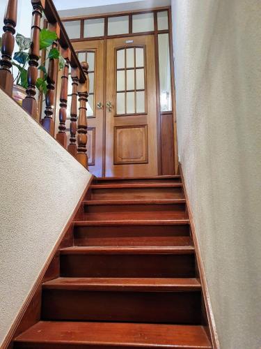 a staircase leading up to a wooden door at TR House Amadora in Amadora