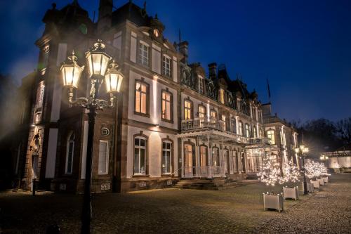 a building with a street light in front of it at night at Château de Pourtalès in Strasbourg