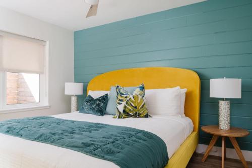 a bedroom with a bed with a blue accent wall at Haley's Court Boutique Motel in Saint Augustine
