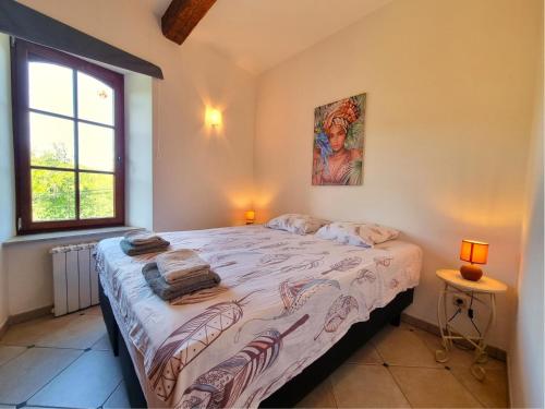 een slaapkamer met een groot bed met 2 lampen erop bij La Roche 8 in Aigues-Vives