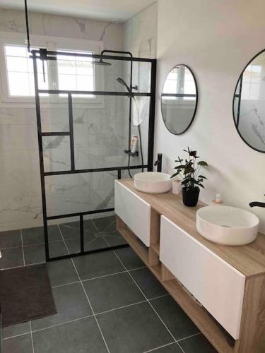 une salle de bain avec deux lavabos et une douche dans l'établissement Maison 3ch avec garage, à Saint-Pavace