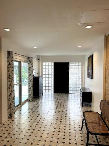 a large room with a hallway with a table and chairs at Villa Patong Beach in Patong Beach