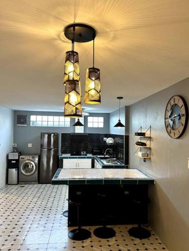 a large kitchen with a sink and a washing machine at Villa Patong Beach in Patong Beach