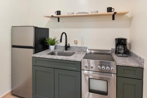 a kitchen with a sink and a stove and a refrigerator at Squam Lake 3 bed plus 3 bath rental (Suite 7) in Holderness